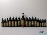 several bottles of different types of skin care products lined up on a white surface