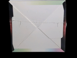 a white box with a piece of paper on top of it