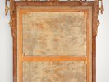 a picture of a mirror hanging on the wall