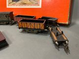 several toy trains are lined up on a table next to a red box