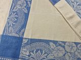 a close up of a blue and white table cloth on a table