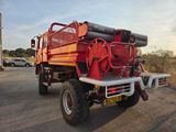 a red fire truck parked in a parking lot