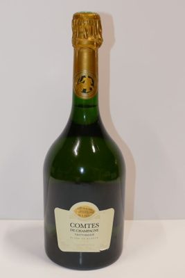 a bottle of champagne sitting on a white table