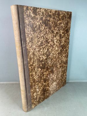 a book with a brown cover sitting on top of a table