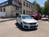 a white car parked in front of a building in a parking lot