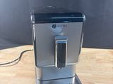 an image of a coffee machine sitting on top of a wooden table
