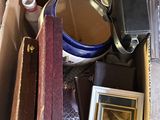 a box full of assorted items that include a picture of a man in a hat