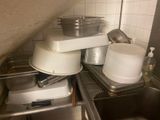 several pots and pans are stacked on top of each other in a kitchen