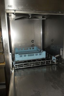 a dishwasher in the middle of a stainless steel oven
