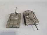 two toy tanks that are sitting on a table