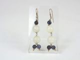 a pair of earrings with blue and white beads on them