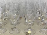 several empty wine glasses sitting on top of a tray on a table