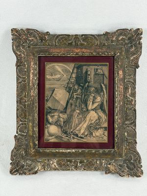 an old picture of a woman sitting on a chair in front of a painting
