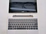 a laptop computer sitting on top of a white table