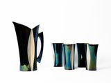 trois vases noirs et blancs posés les uns à côté des autres sur une surface blanche