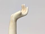 a statue of a hand holding a tennis racquet