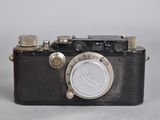 an old camera sitting on top of a table with a white background