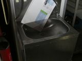 a metal sink with a box on top of it