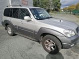 a picture of a silver suv parked in a parking lot
