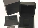 a black box with a black watch inside of it