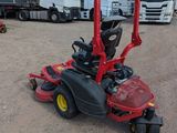 a picture of a red riding lawn mower in a parking lot