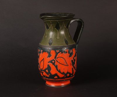 a black and orange vase on a black background