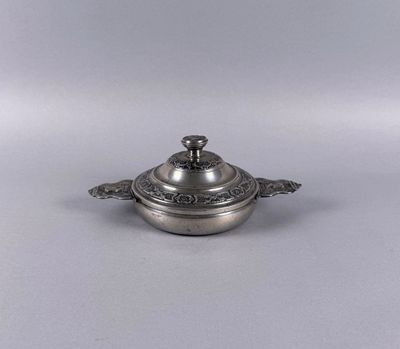 a silver plate with a lid and a handle on it