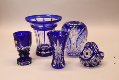 a lot of blue glass items sitting on a table