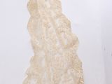 a piece of lace on a white surface next to a pair of scissors