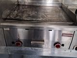 an image of a commercial gas grill in a commercial kitchen