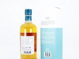 an image of a bottle of alcohol sitting next to a box