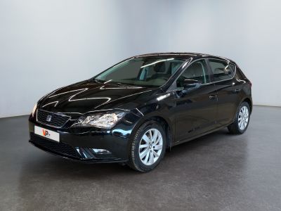the black car is parked in a large room with a white wall