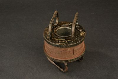 a small metal object on a black surface