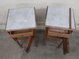 two wooden tables with marble tops on top of them
