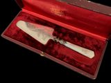 a small knife in a red box with a silver handle