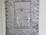 a black and white photo of a wall with a picture on it