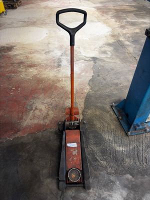 a shovel that is sitting on the ground next to a pole