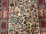 an image of a rug with a pattern of flowers and birds on it