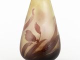 a glass vase with a brown and white design on it