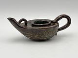 an old teapot with a handle and a handle in the shape of a bird