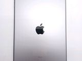 an apple ipad sitting on top of a white table next to a white wall