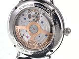 a close up of a watch on a white surface