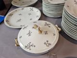 many plates that are sitting on a table with a horse on them