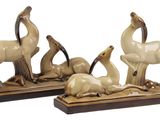 two figurines of animals that are sitting on top of each other