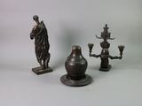 three bronze figurines that are sitting on a table