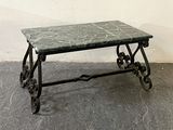 a table with a marble top on wheels on the floor