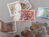 a lot of money and coins on the table