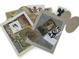 a pile of assorted cards and other items on a white surface