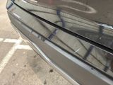 a close up of a car with graffiti on the side of it