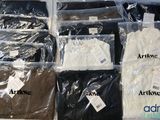 a lot of t - shirts that are sitting on a table